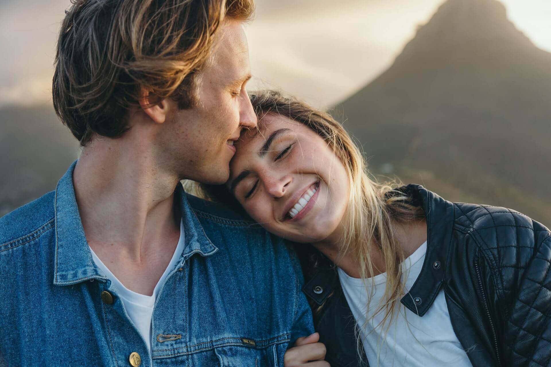 Happy loving woman resting head on boyfriend's shoulder