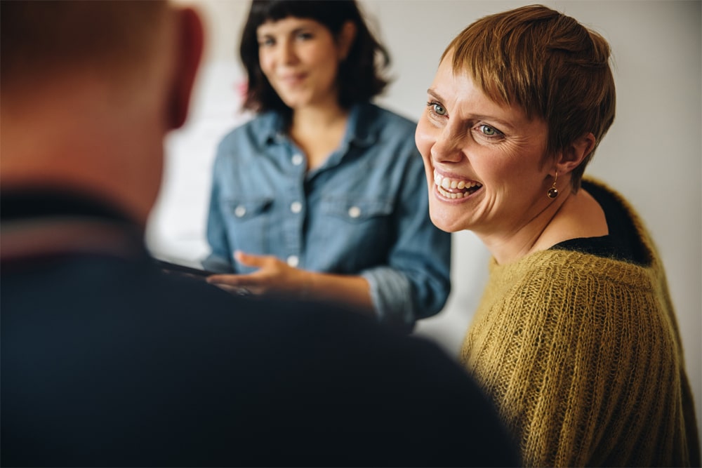 Three people talking and laughing