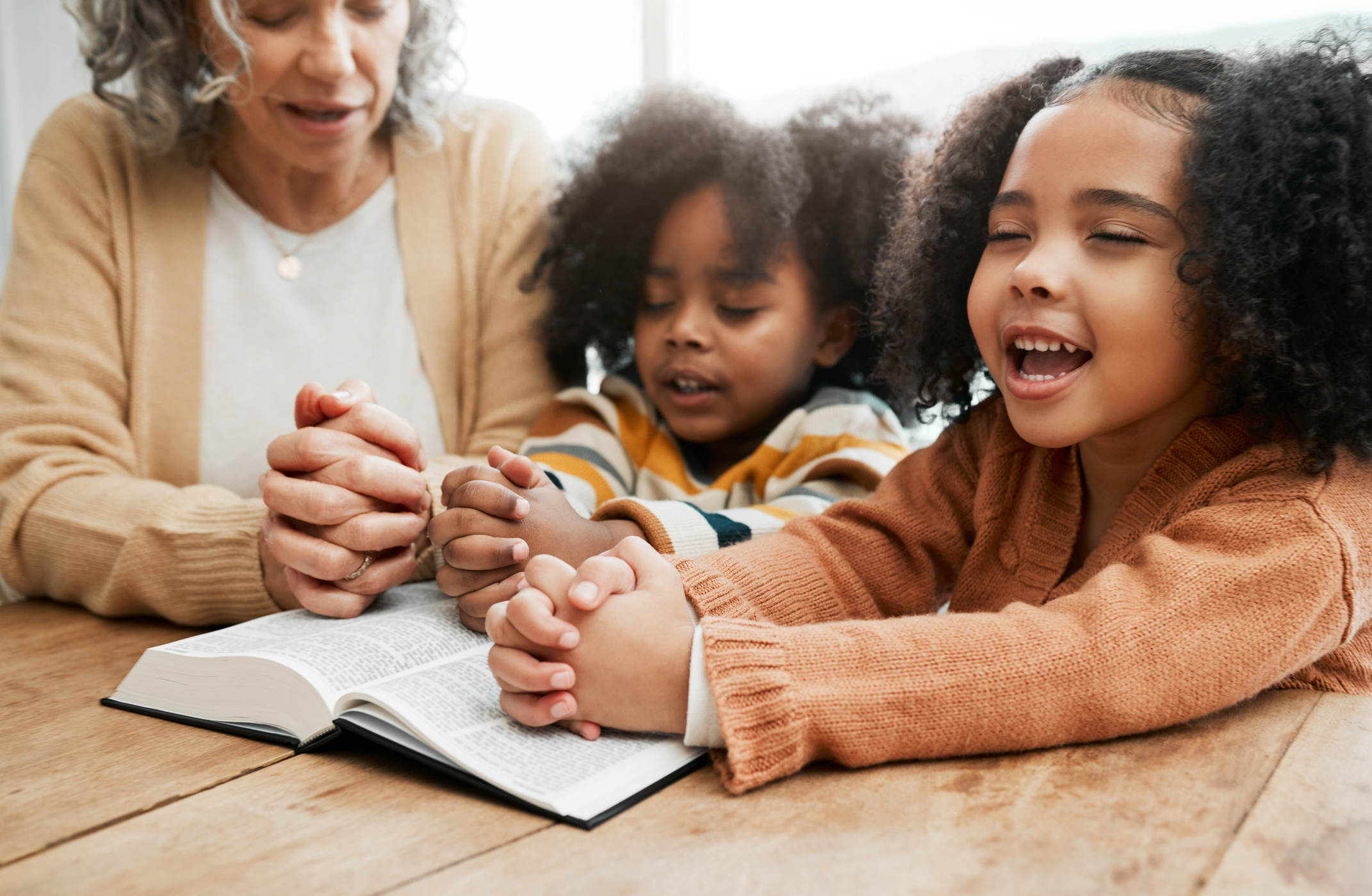 children reading and praying