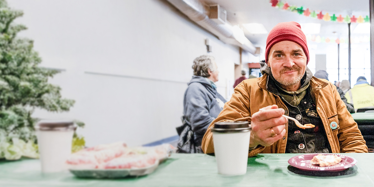 A happy man eating a meal during the holiday season